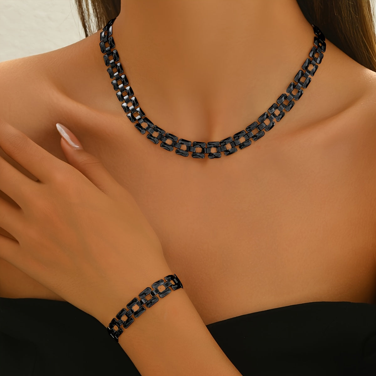 Panel-link necklace and bracelet set in black, worn front view