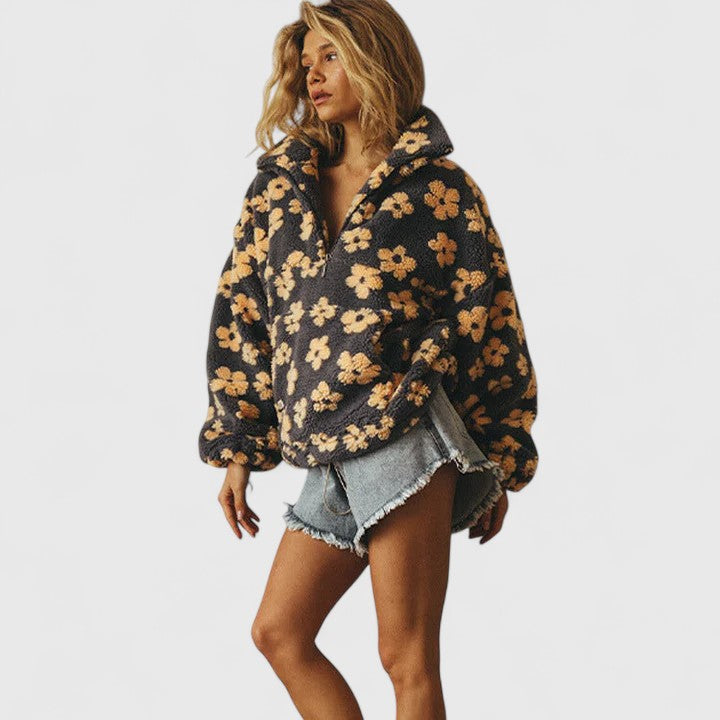 Delysanne sweater in grey with yellow flowers, side view with denim shorts