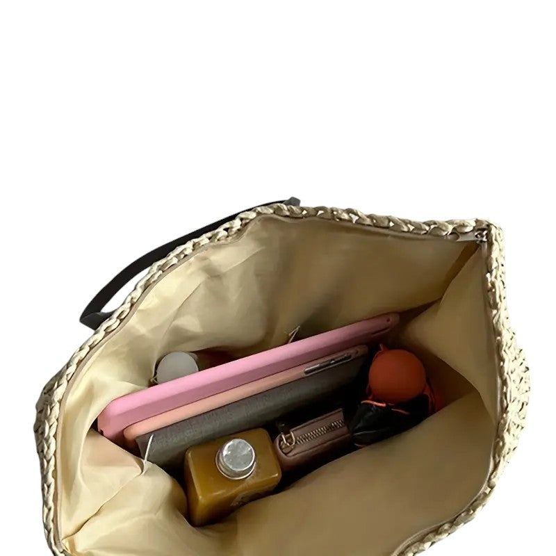 Open interior of the large woven tote bag holding phone and purse