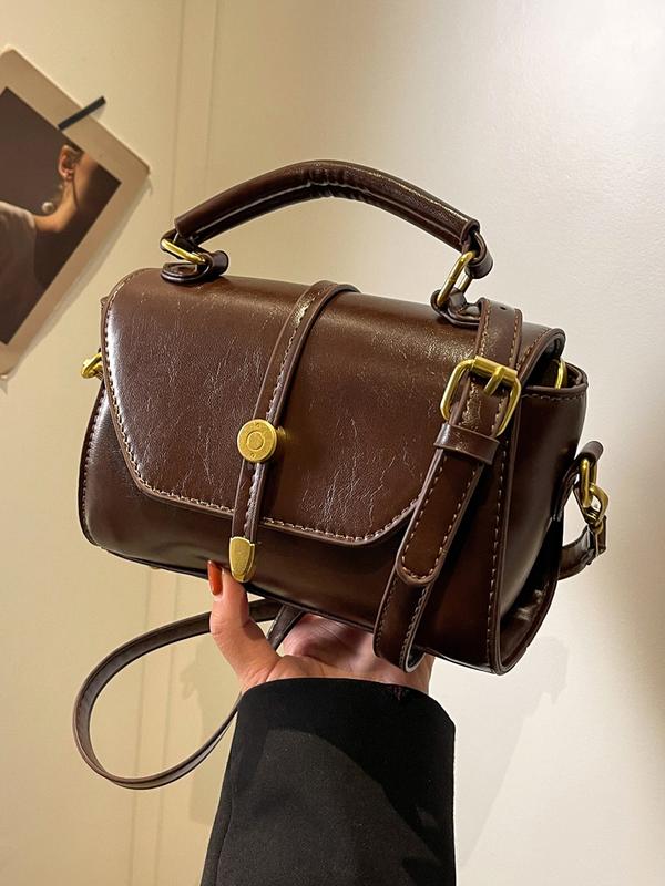 Alwina shoulder bag in dark brown, front view with flap closed