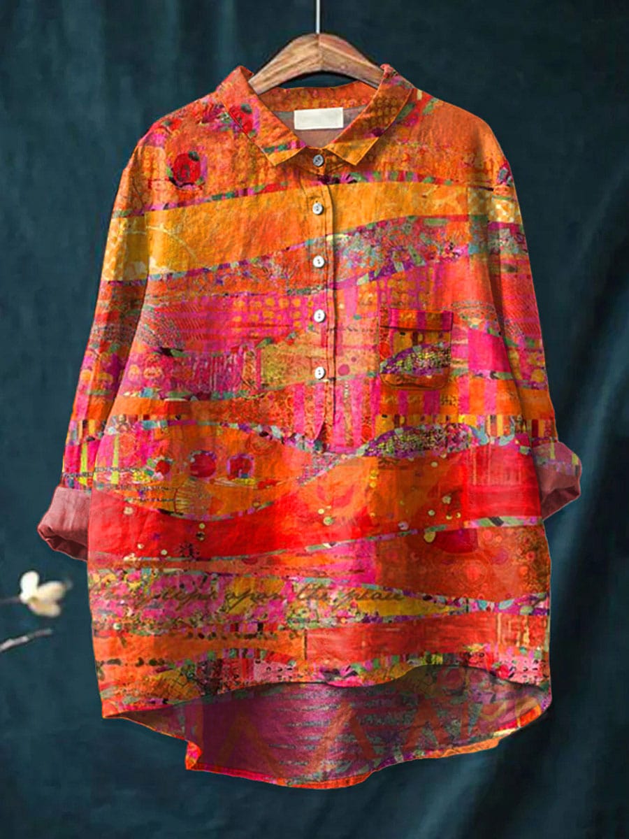 Aurielle blouse in orange and pink painted print, front view on hanger