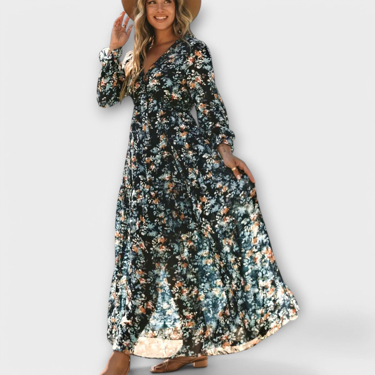 Maya floral V-neck maxi dress in navy blue floral, worn with a straw hat
