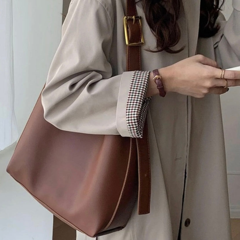 Isolde shoulder bag in brown worn with a beige trench coat