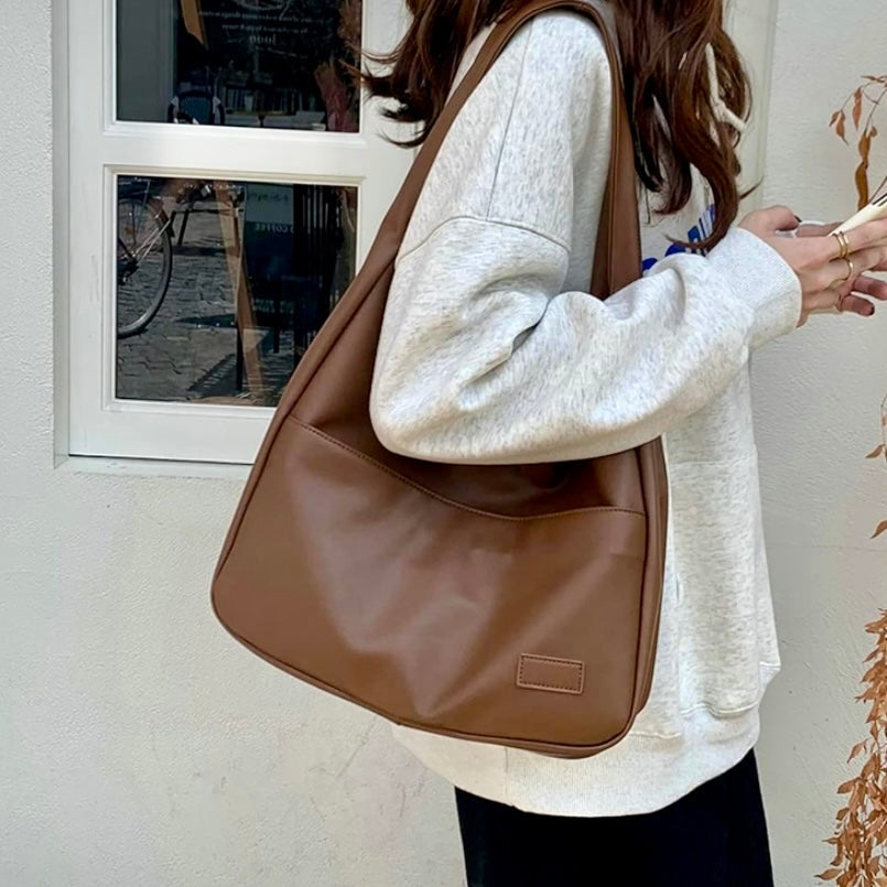 Fiora slouchy shoulder bag in brown, worn over the shoulder
