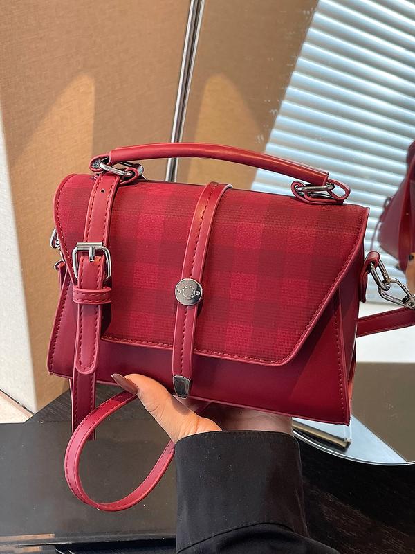 Alwina shoulder bag in red check, front view held in hand