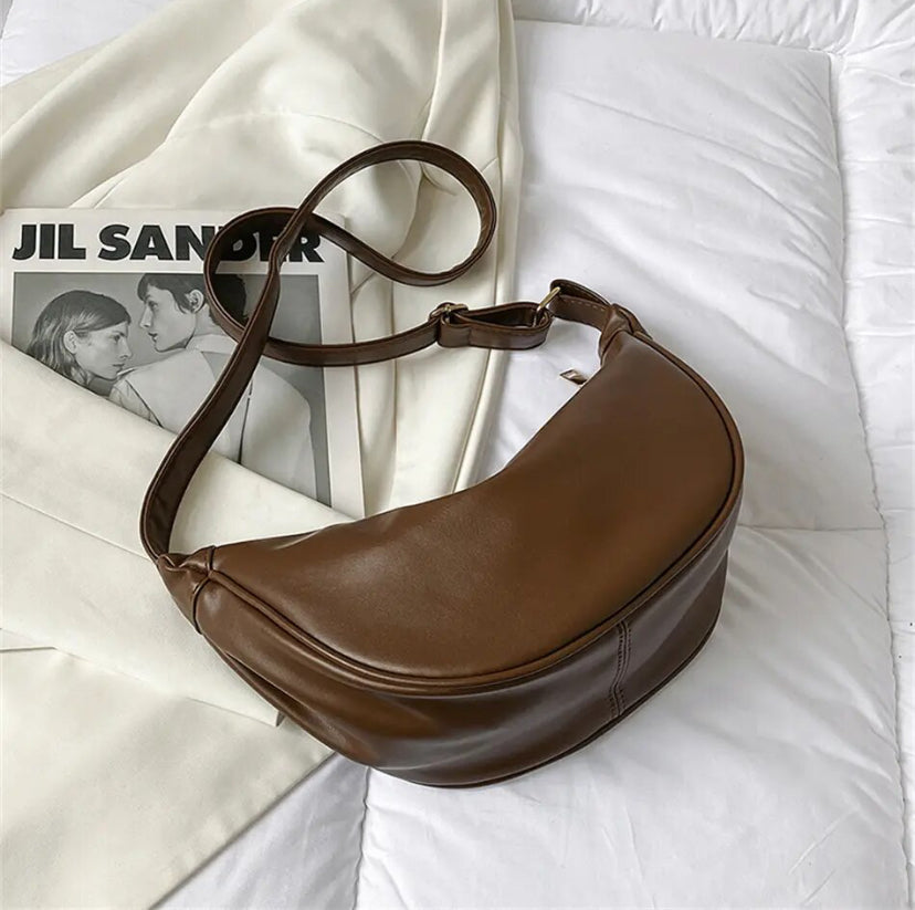 Maribel petite crescent bag in coffee brown laid flat with strap coiled