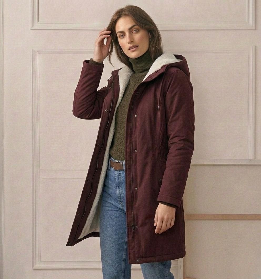 Marjorie hooded coat in berry red worn open over a knit