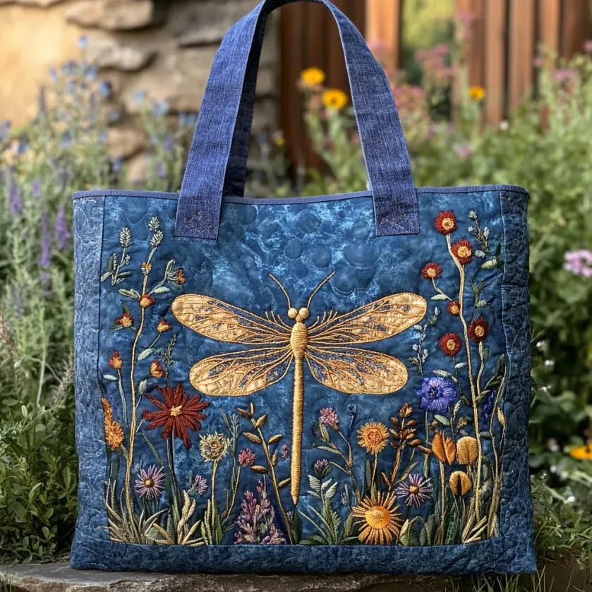 Handcrafted tote bag in blue with golden dragonfly and wildflower embroidery, front view