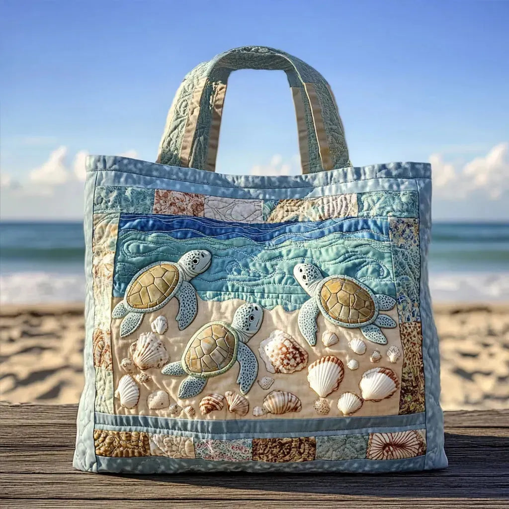 Handcrafted quilted sea turtle tote bag in blue and sand, front view