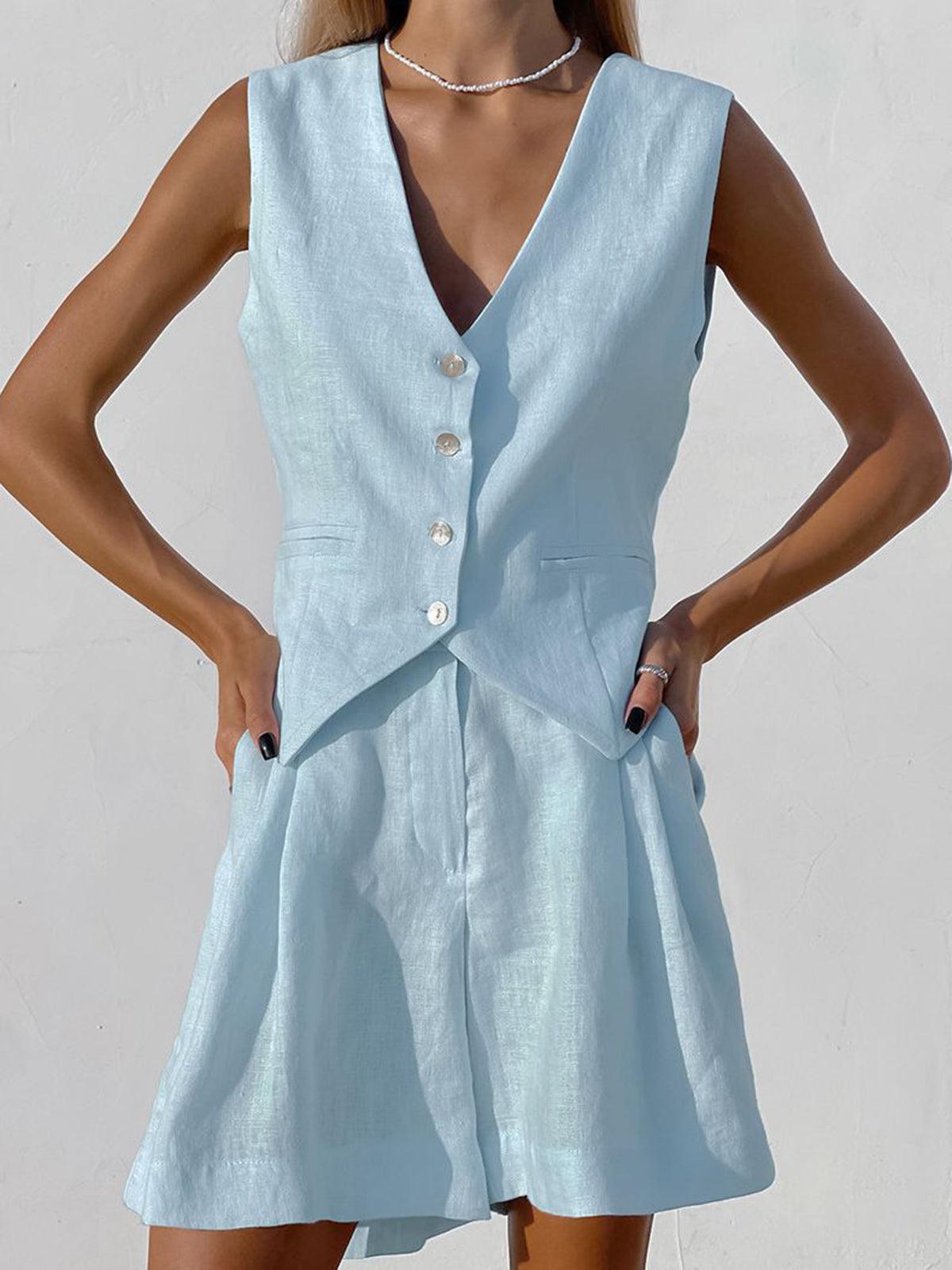 Sophia waistcoat top in light blue, close view of button front and pockets