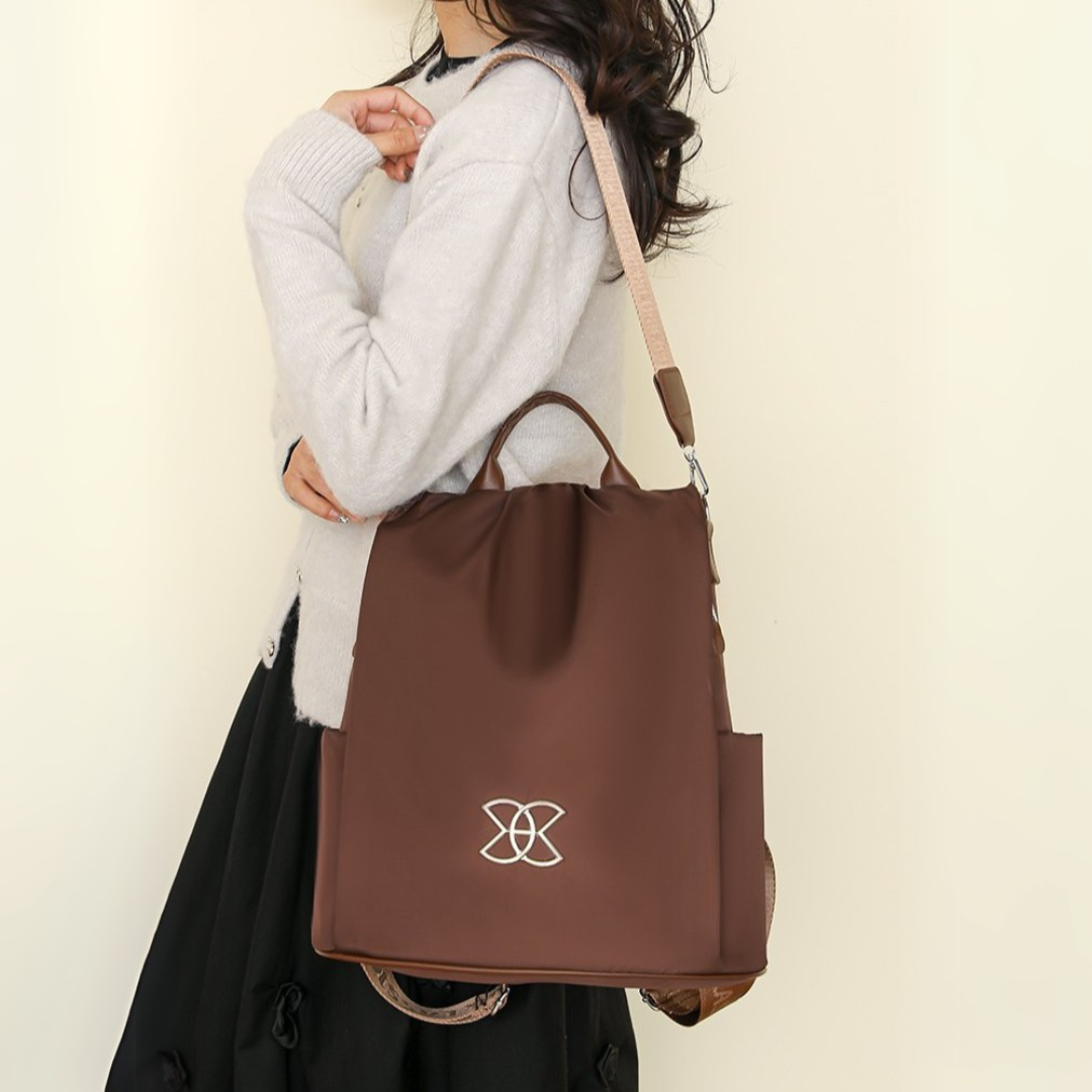 BeBold backpack in brown carried as a shoulder bag