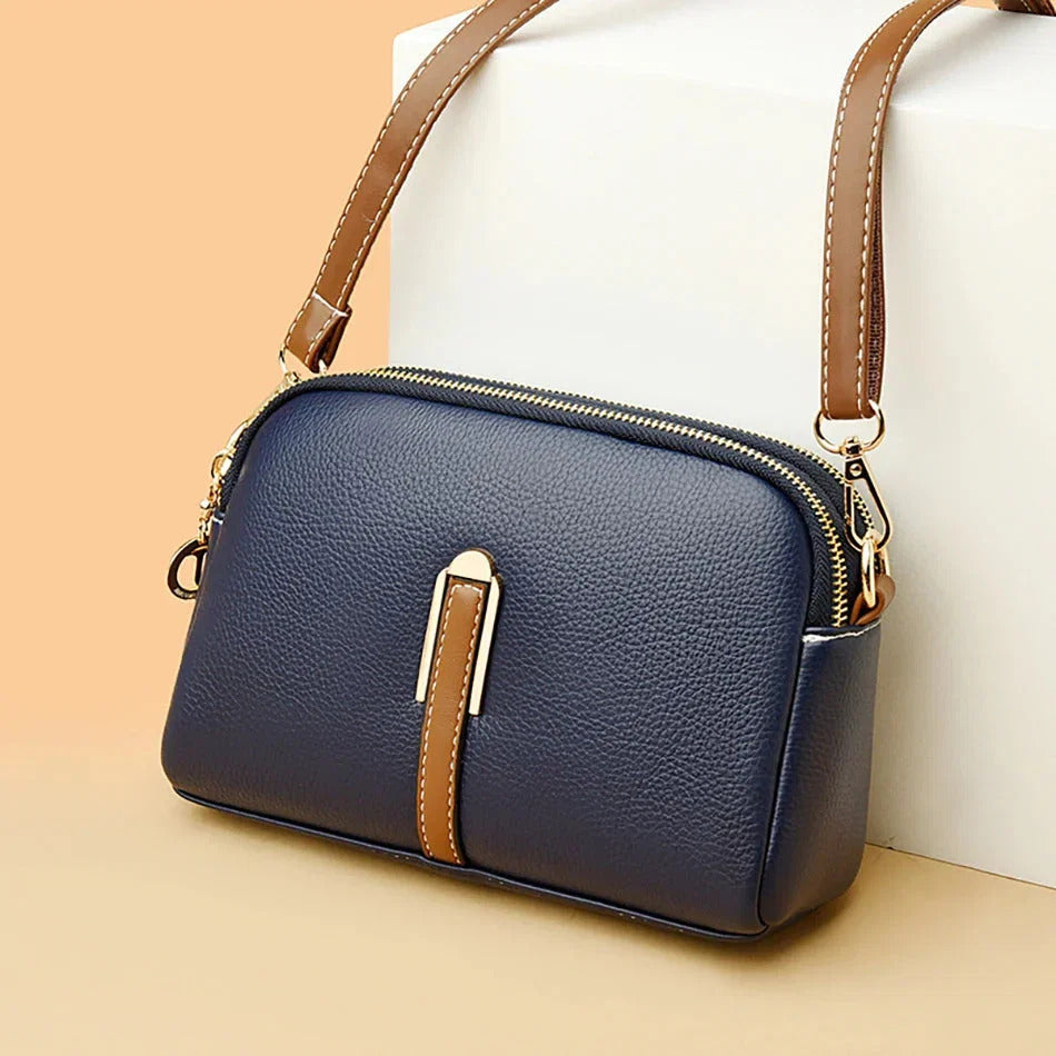 Emanuela crossbody bag in navy blue, angled front view