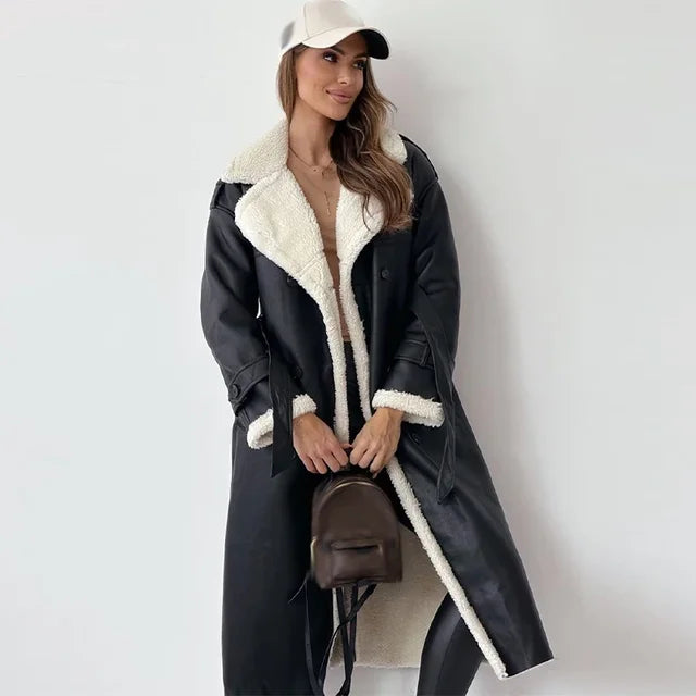 Thalissa long trench coat in black worn with cream cap, front view