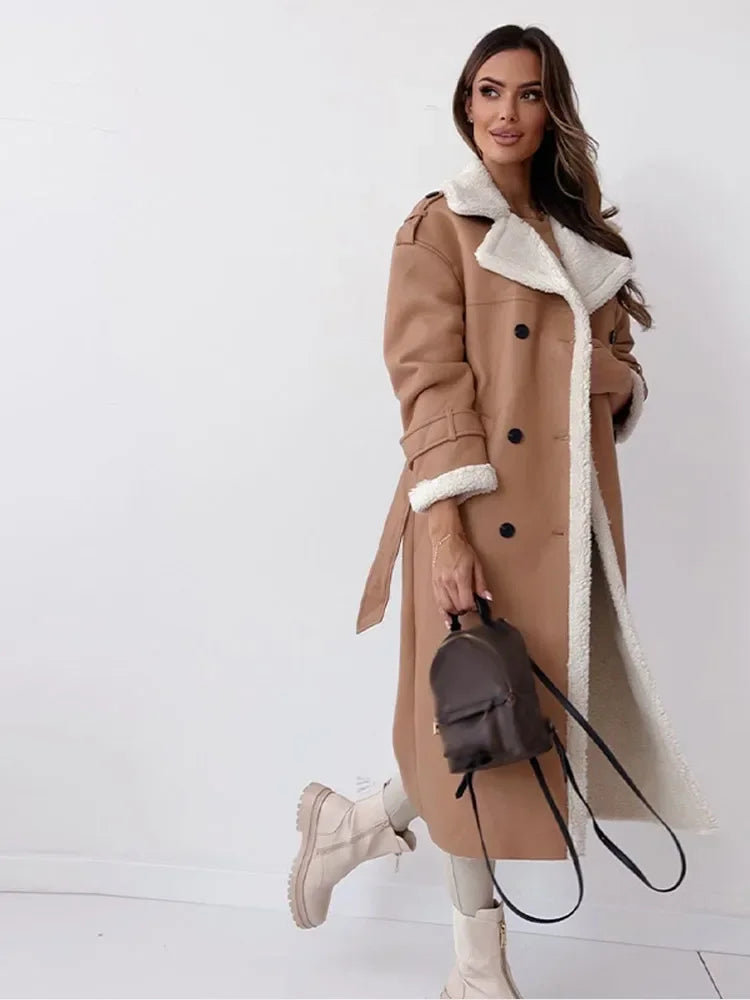 Thalissa long trench coat in brown worn with cream boots, front view