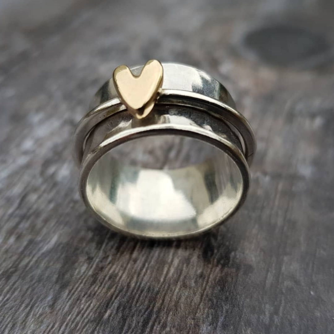Golden heart silver ring with polished wide band, close-up front view