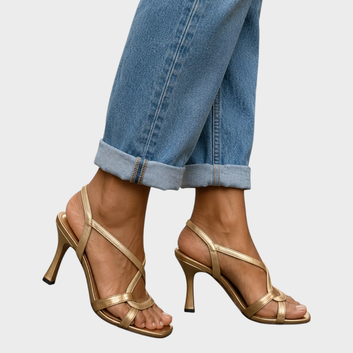 Margot gold strappy heeled sandals in gold, side view showing slim heel