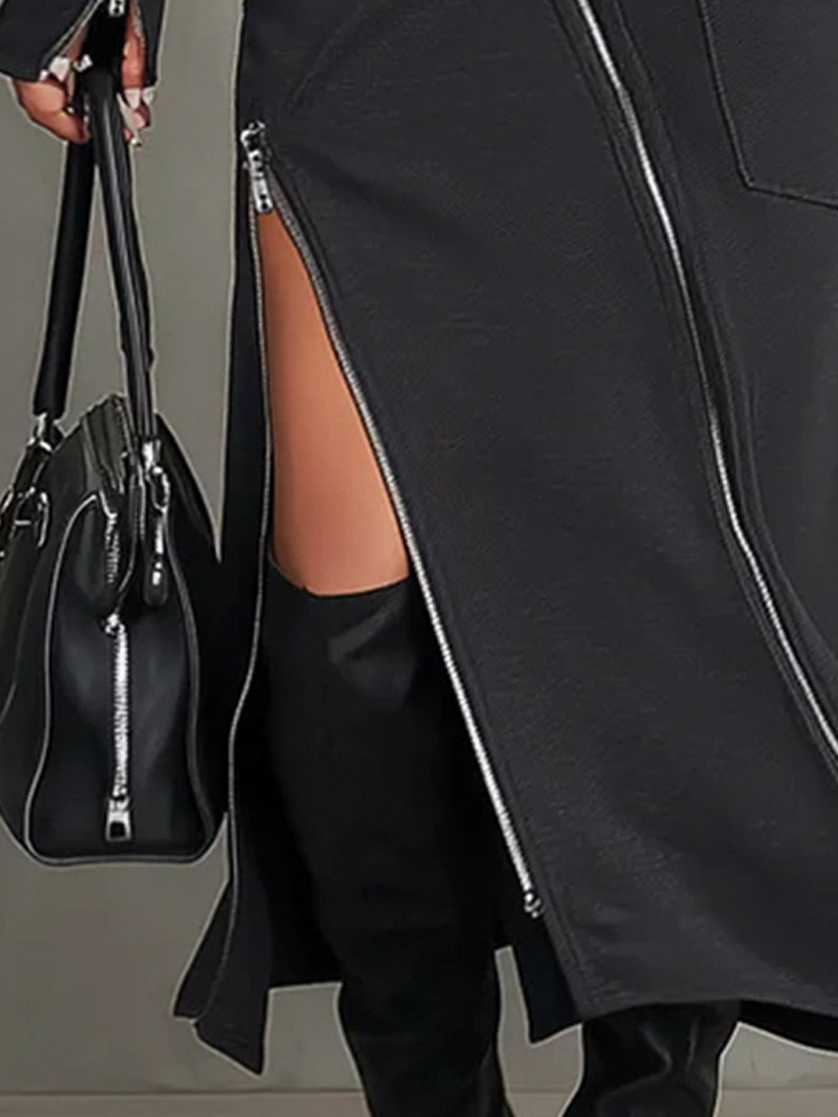 Detail of the Elena skirt zip slit and hem in dark grey