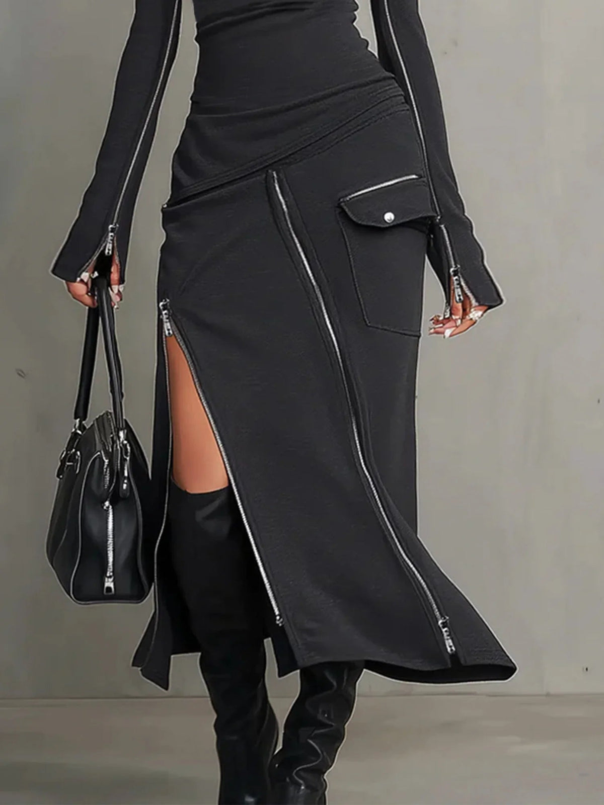Close-up of the Elena skirt zips and flap pocket in dark grey