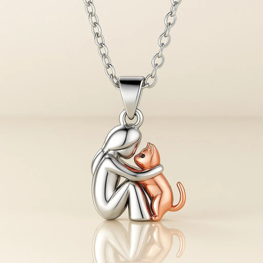 Islara cat necklace pendant in silver and rose gold on a light background