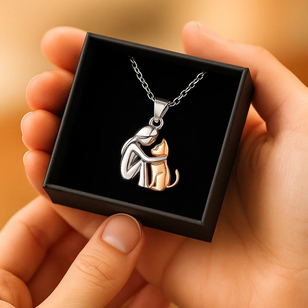 Islara cat necklace in silver and gold held in a black gift box