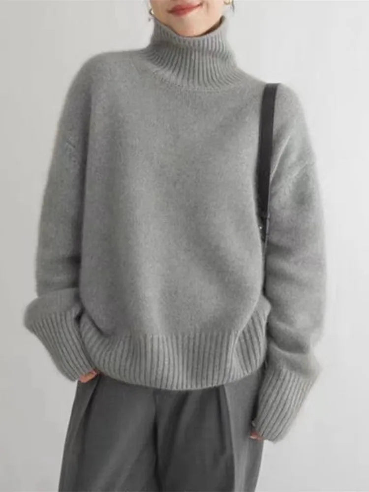 Isaboll high-neck sweater in grey, front view worn with trousers