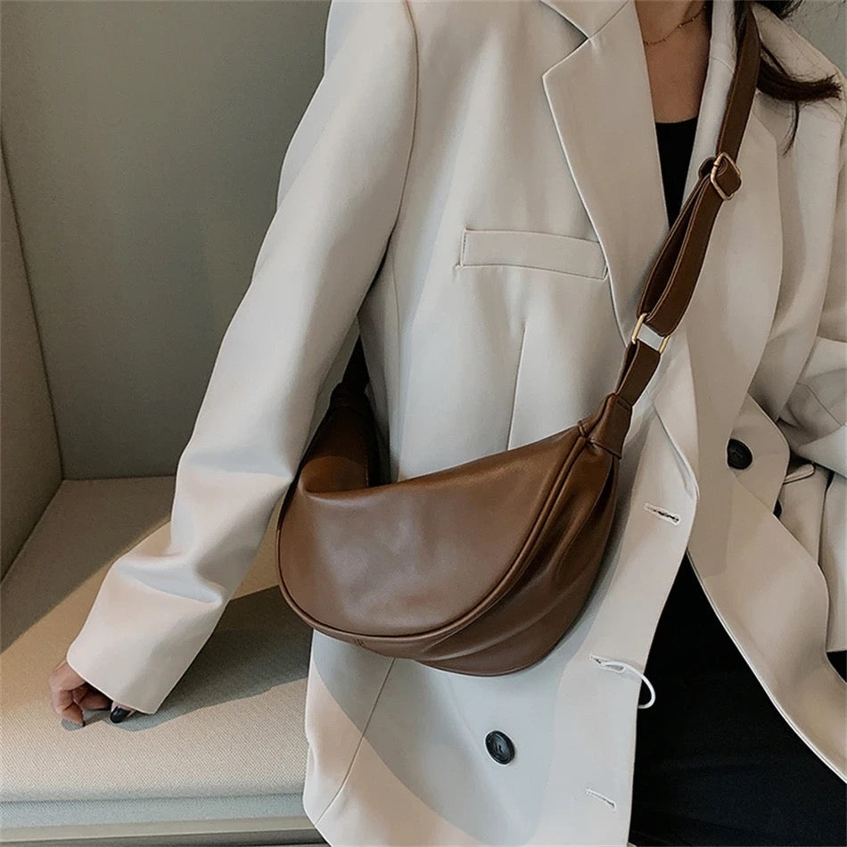 Maribel petite crescent bag in coffee brown worn crossbody over a cream blazer