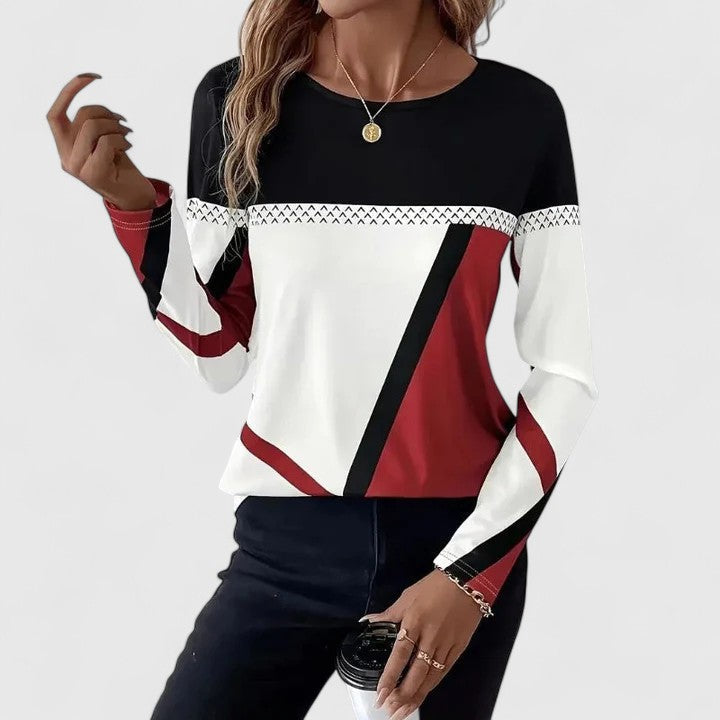 Kristah elegant sweater in black, white and red, front view worn with dark jeans