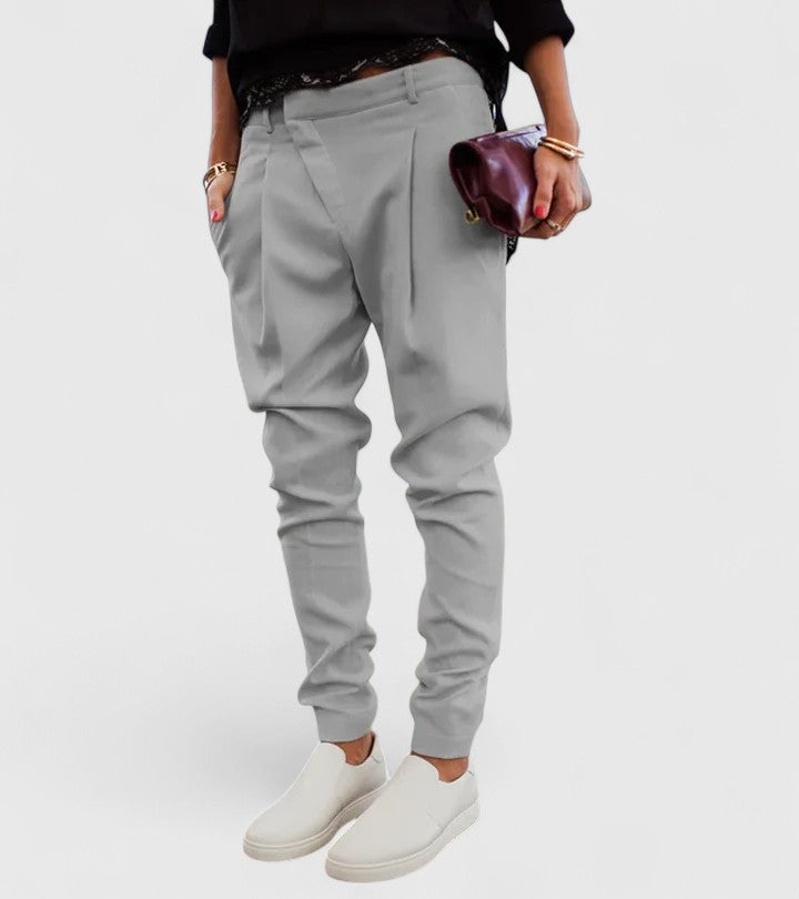 Marceline elegant tapered trousers in grey, styled with white slip-on shoes