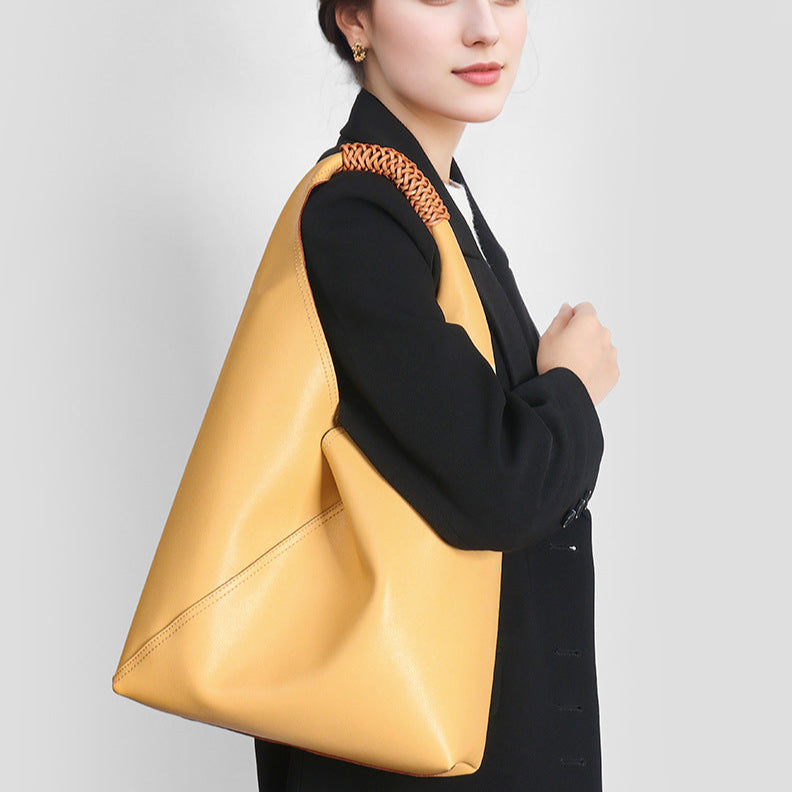 Sienna slouchy top handle bag in yellow carried on the shoulder