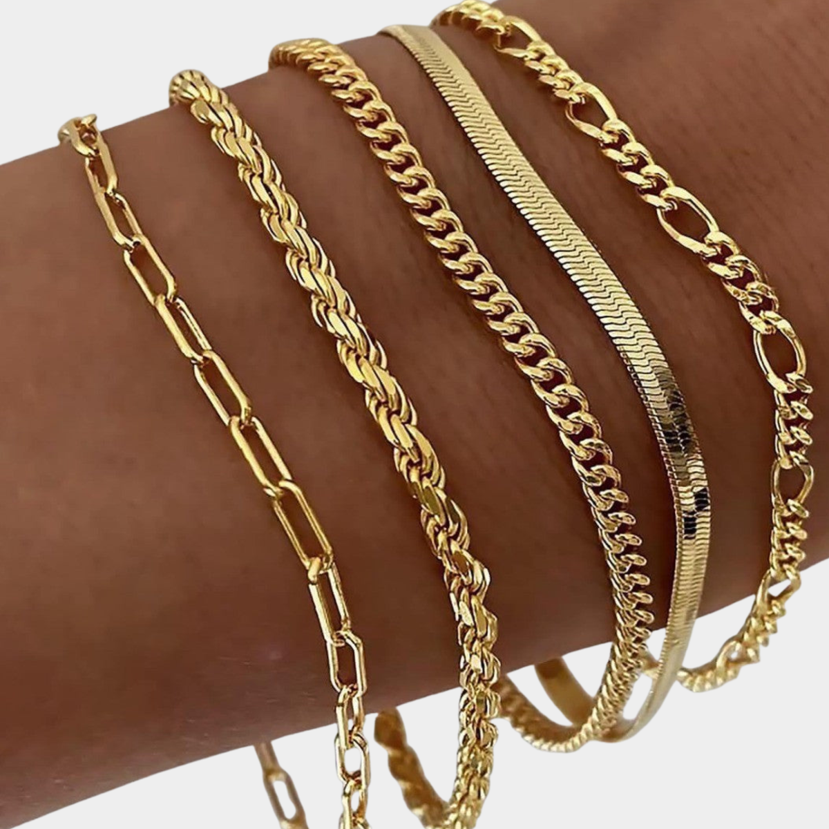 Juna bracelet set in gold, five mixed chains worn stacked on the wrist