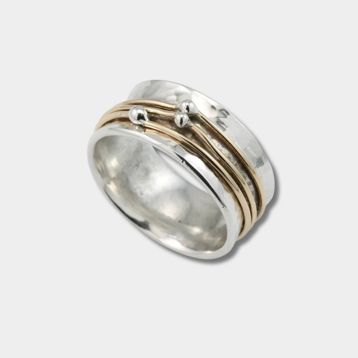 Marlene wide hammered ring in silver with gold accent bands, angled view