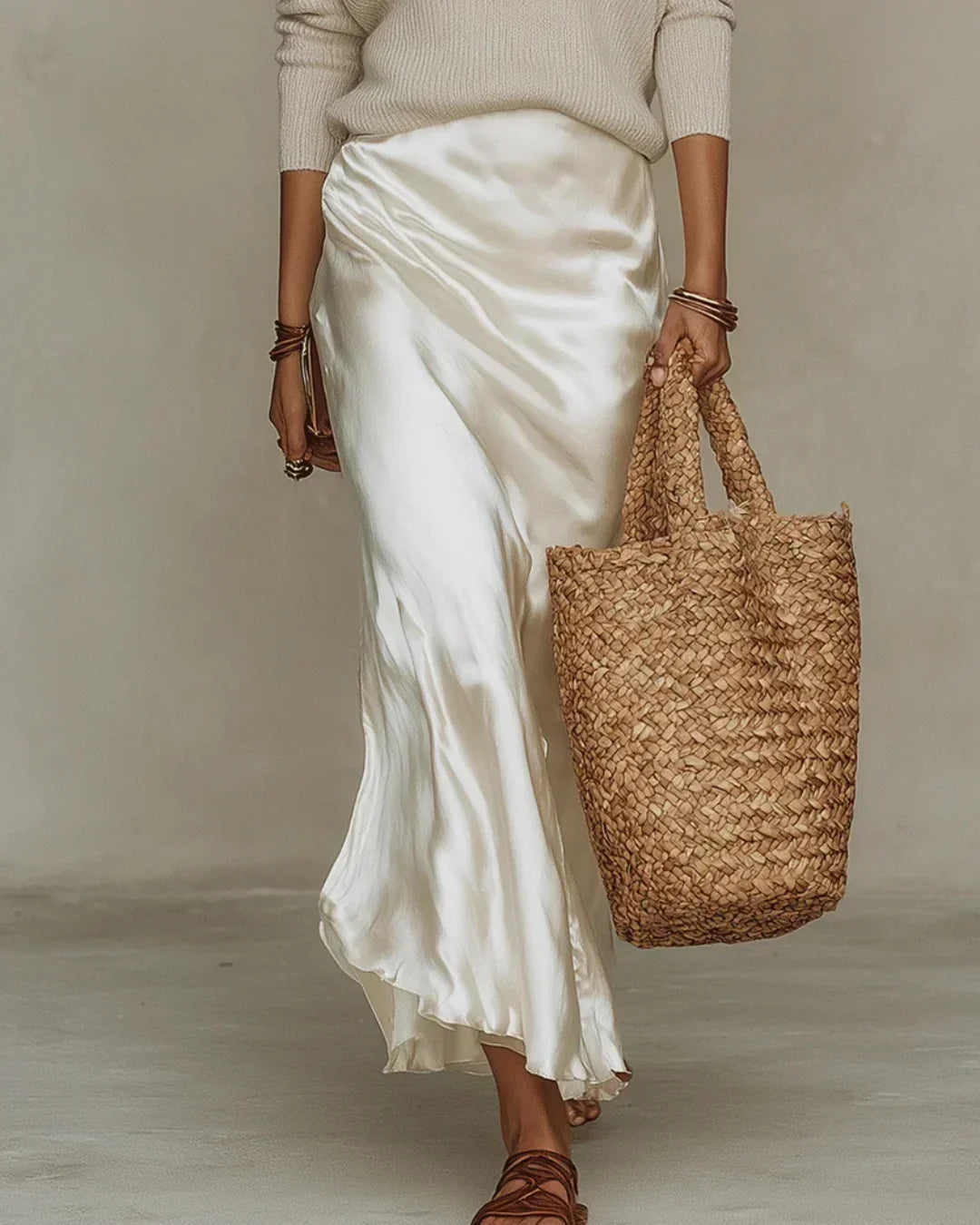 Brisa satin skirt detail in white, close view of flowing hem