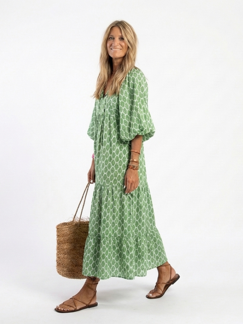 Apolline patterned midi dress in green, walking side view