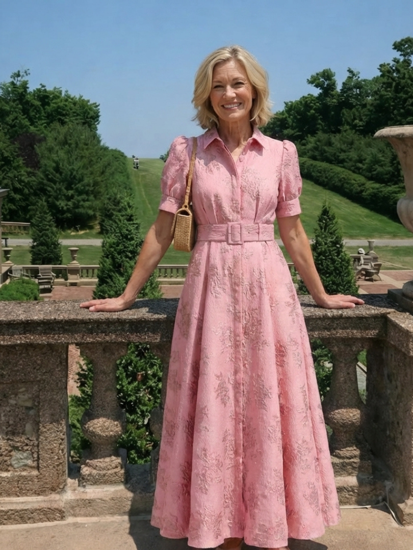 Xanthea pink belted shirt dress worn outdoors on a garden terrace