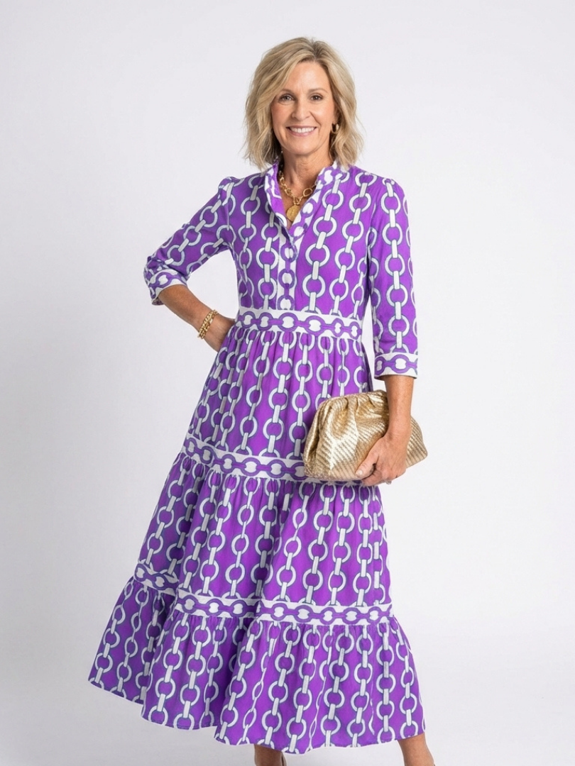 Ysolde chain pattern midi dress in purple with gold clutch, front view