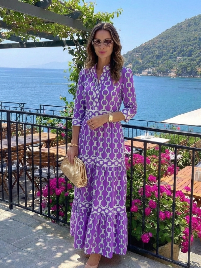 Ysolde chain pattern midi dress in purple, styled on a seaside terrace