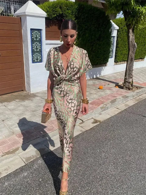 Clarandra copper midi dress in green print, full-length view in sunlight