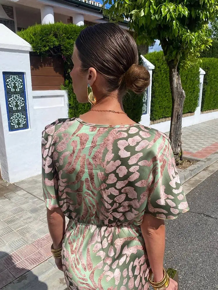 Clarandra copper midi dress in green print, back view of flutter sleeves