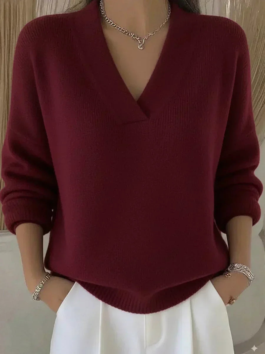 Violeta relaxed V-neck jumper in red, front view worn with white trousers