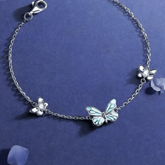 Butterfly bracelet on blue background showing flower stations and clasp