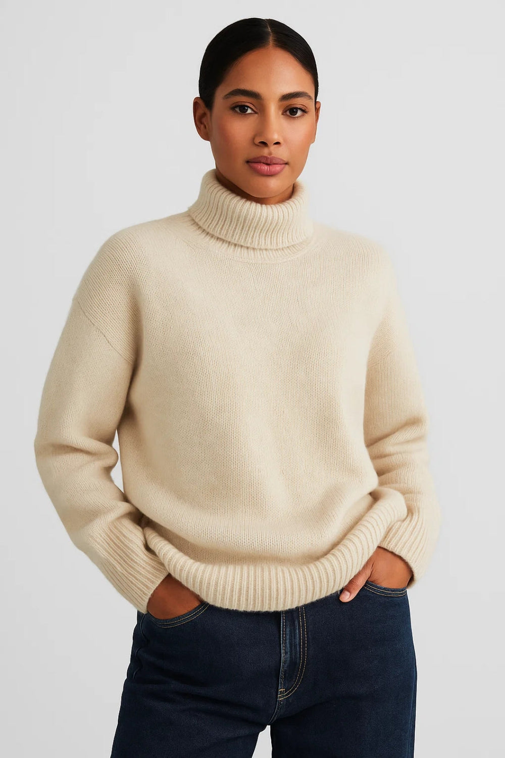 Meliora loose-fit roll-neck knit sweater in cream, front view on model