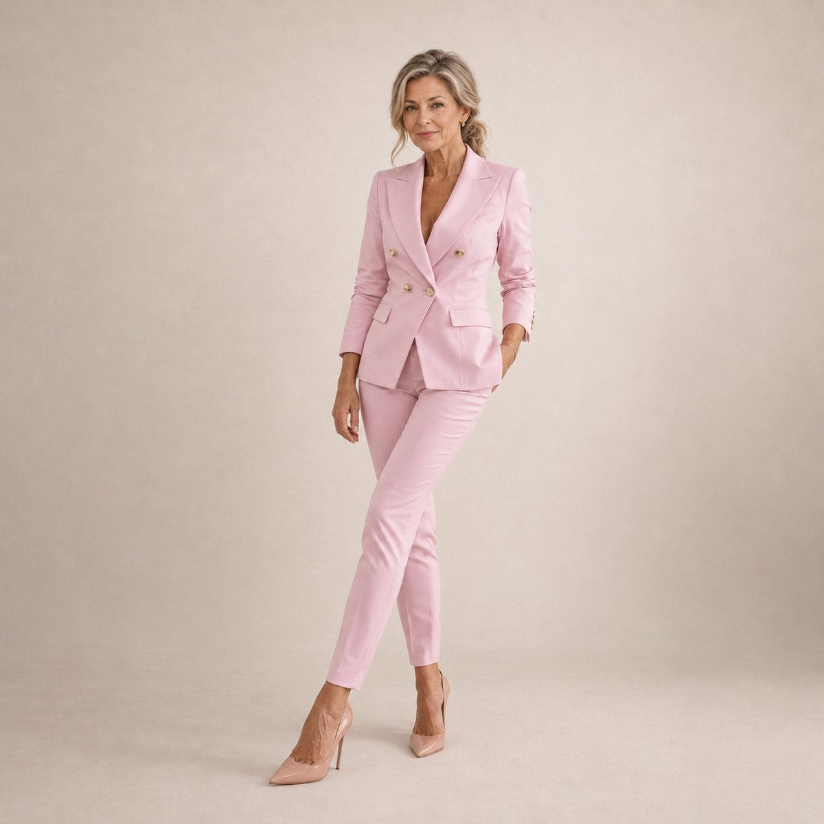 Octavia double-breasted trouser suit in pink with gold buttons, full-length view