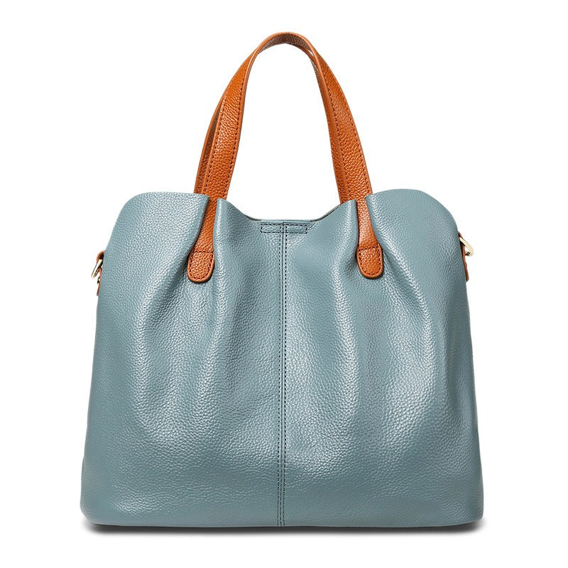 Alana tote bag in blue with tan handles, front view