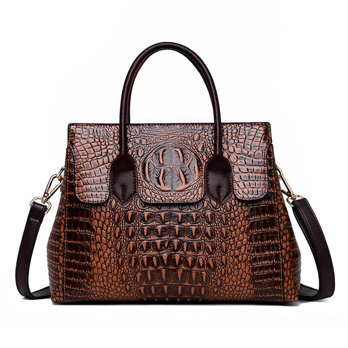 Crocodile-embossed designer handbag in auburn, front view with twin handles