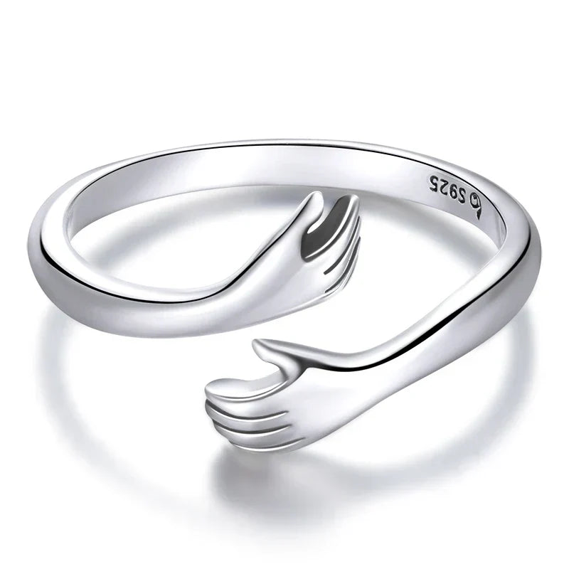 Hug hands minimalist ring in silver, close-up of open band