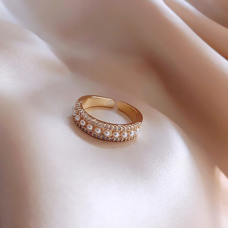 Gold and pearl ring showing the open adjustable band from above