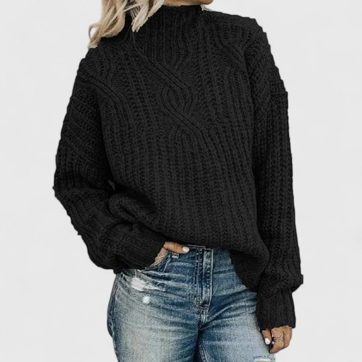 Aerynna cable-knit sweater in black, front view with jeans