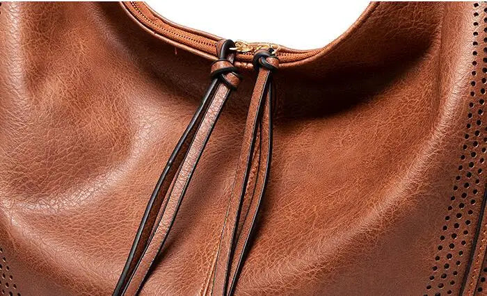 Ysolde leather hobo bag in brown, close-up of knotted tassel ties