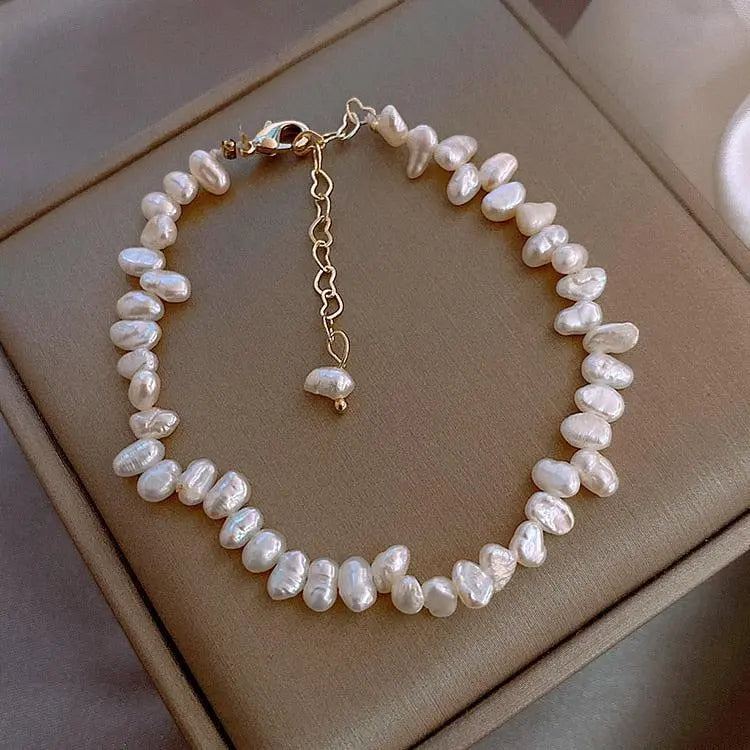 Classic pearl bracelet in white with gold extender chain, boxed view