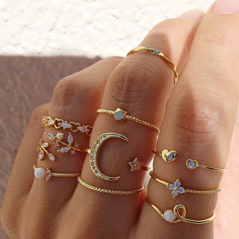 Gold bohemian ring pack worn stacked across the fingers of one hand